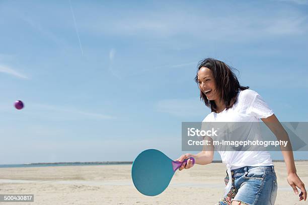 Woman Playing Paddle Ball Stock Photo - Download Image Now - Beach, Tennis, Women