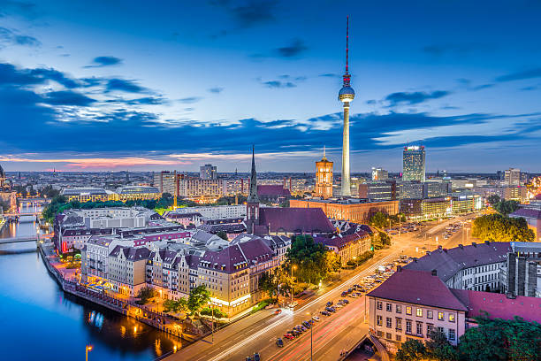 Berlin skyline panorama in twilight during blue hour, Germany Aerial view of Berlin skyline with dramatic clouds in twilight during blue hour at dusk, Germany berlin germany urban road panoramic germany stock pictures, royalty-free photos & images