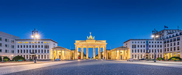 Pariser Platz with Brandenburg Gate at dawn, Berlin, Germany Panoramic view of Pariser Platz with famous Brandenburger Tor (Brandenburg Gate), one of the best-known landmarks and national symbols of Germany, in twilight during blue hour at dawn, Berlin, Germany. brandenburg gate photos stock pictures, royalty-free photos & images