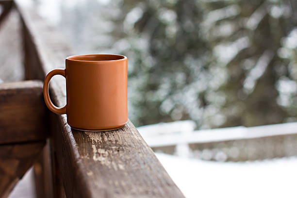 istock Cup with hot drink over winter forest background 500431116