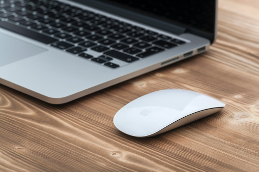 Çanakkale, Turkey - December 8, 2015: 13-inch Apple MacBook Pro.with Apple magic mouse 2 on table.