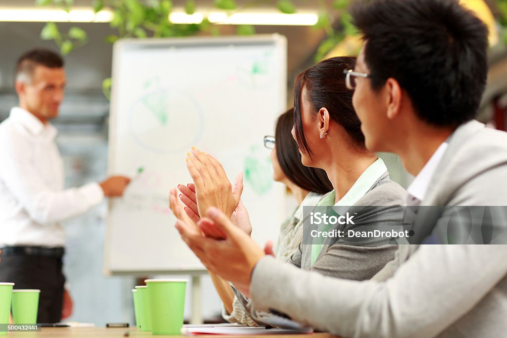 Business people applauding in a meeting Business people applauding in a meeting. Business concept. Achievement Stock Photo