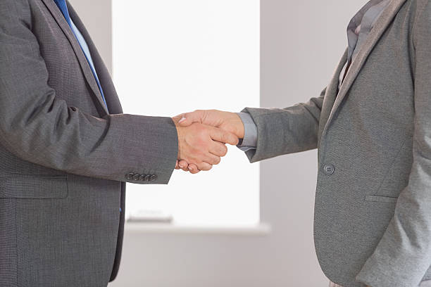 istock Close up on two businesspeople shaking hands 500432599
