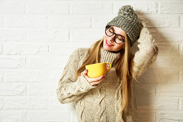 Romantic Dreaming Hipster Girl in Winter Clothes with a Mug stock photo