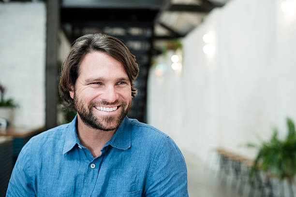 Mid adult man with beard looking away smiling portrait