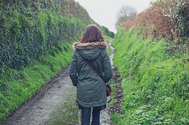 istock Woman walking on country road 500435186