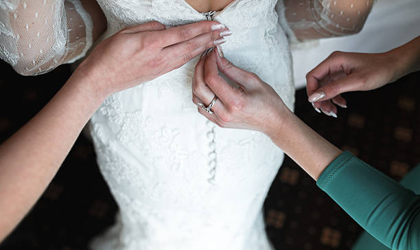 istock Bride putting on her dress 500435620