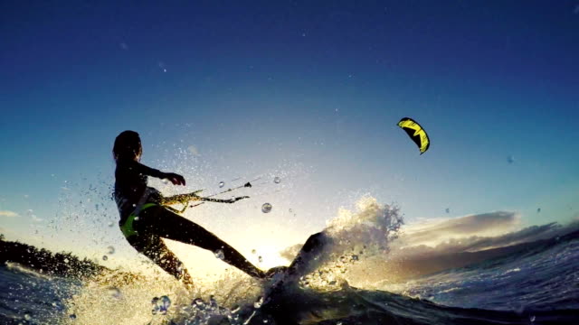 Extreme Kitesurfing Girl at Sunset. Summer Ocean Sport in Slow Motion.