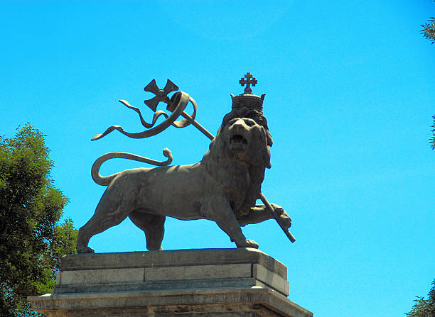 Addis Ababa, Ethiopia: Lion of Judah Addis Ababa, Ethiopia: Lion of Judah monument - Anbessa square, outside the railway station - taken to Rome in the 1930s by Mussolini's troops and only returned in the 1960s - symbol of the Israelite tribe of Judah and a national symbol of Ethiopia - seen against blue sky - photo by M.Torres addis ababa lion stock pictures, royalty-free photos & images