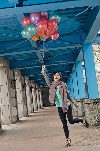 istock Cheerful Asian beauty holding balloons 500443501