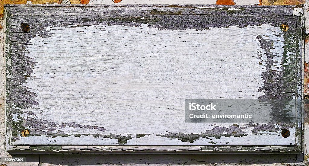 Old white wooden signboard. Old white wooden sign on a brick wall. Brick Wall Stock Photo