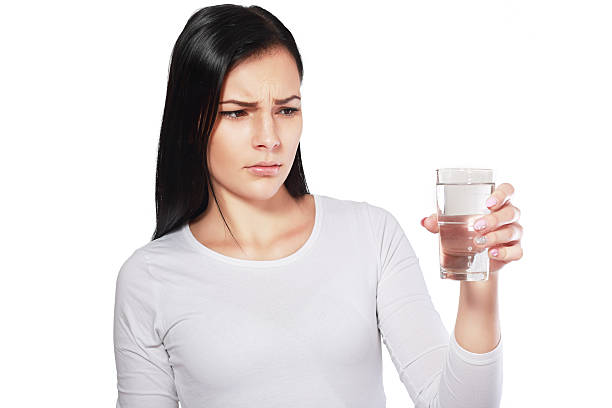 asian woman looking at water looking unhappy stock photo