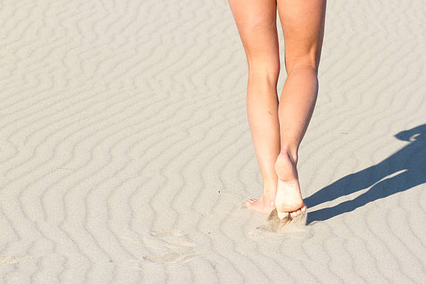 istock Women's legs from behind. Recreation. Blue sea 500451620