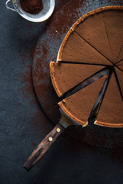 istock Sliced chocolate tort on dark background 500453074