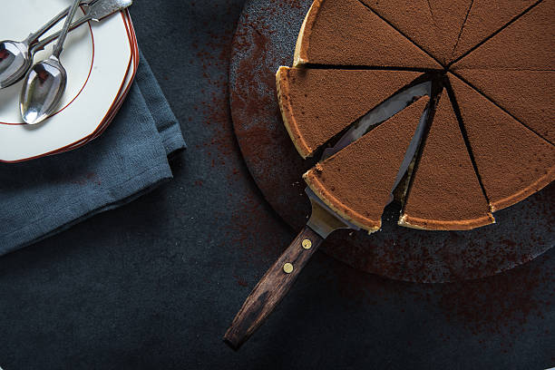 istock Sliced chocolate tort on dark background 500453354