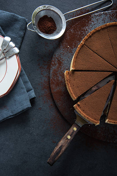 istock Sliced chocolate tort on dark background 500453476