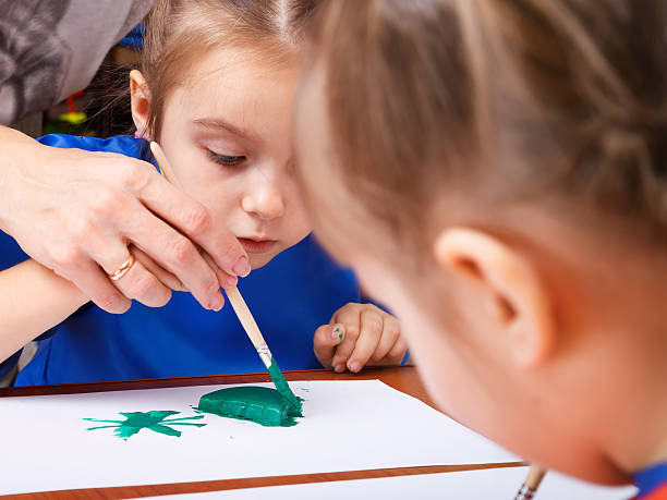 istock Little girl is painting 500454308