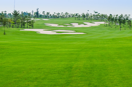 landscape view of sand trap on the green grass at golf course, Thailand