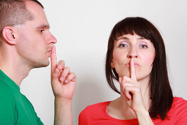 istock Woman and man showing hand silence sign 500457817