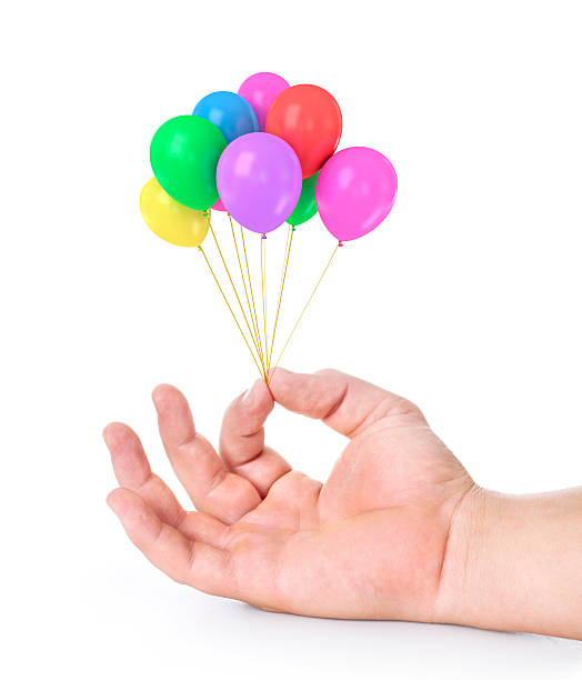 istock Hand holds colorful balloons isolated on white 500457939