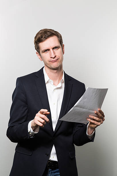 istock businessman with sheet of paper 500458056