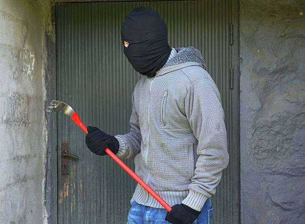 istock Burglar with balaclava and wrecking bar 500458059
