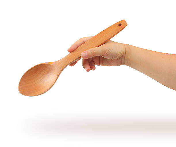 istock Wooden Spoon and hand with clipping path 500458159