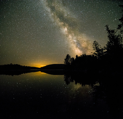 Milky way rising over Prong Pond in Maine. High ISO.
