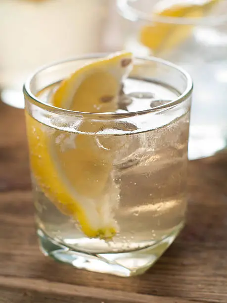 Cold fresh lemonade with lemon, selective focus