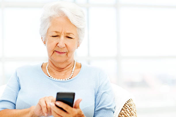 istock Senior Woman Text Messaging Through Smart Phone 500459497