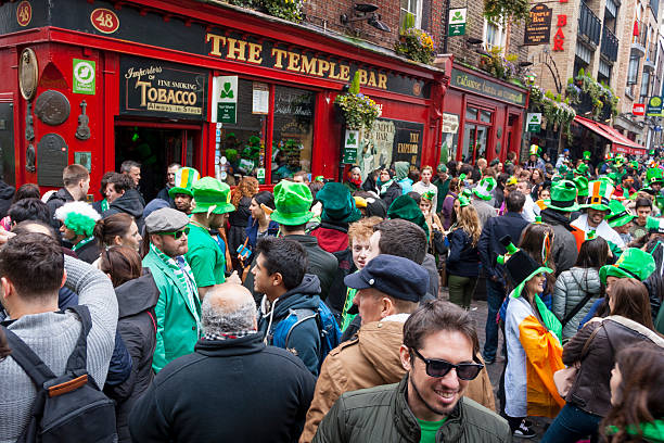 Dublin, Ireland - March 17: Saint Patrick's Day parade Dublin, Ireland - March 17, 2014: Saint Patrick's Day parade in Dublin Ireland on March 17, 2014: People wearing the typical clothes of Saint Patrick's at The Temple Bar in Dublin temple bar pub stock pictures, royalty-free photos & images