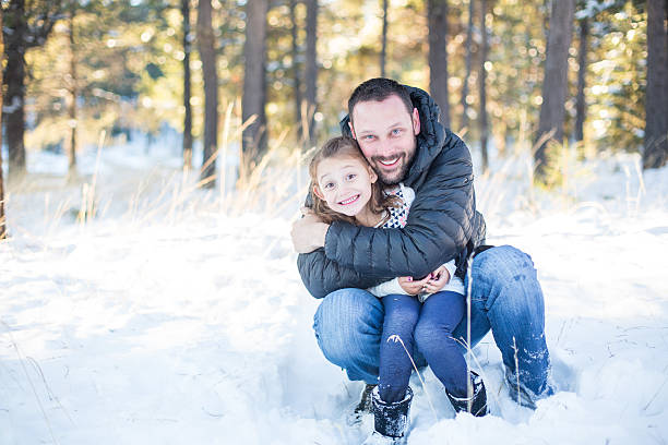 istock Beautiful multi-ethnic family posing and playing in the snow 500460024