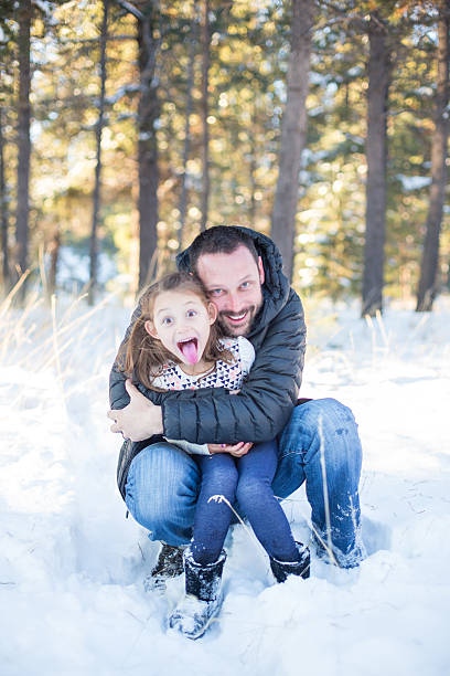 istock Beautiful multi-ethnic family posing and playing in the snow 500460070