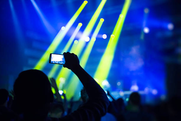 istock taking pictures  during a music concert 500460644
