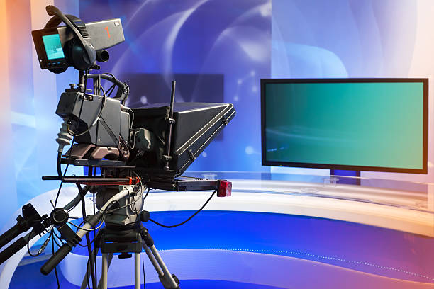 istock TV NEWS studio with camera and lights 500461051