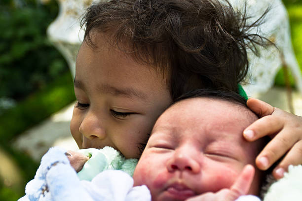 istock Two brothers sitting down huggin each other and smiling 500461991