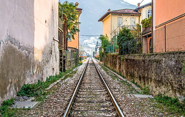 Brescia, Italy - February 16, 2013: the train tracks that pass through the town of Pisogne Lake Iseo