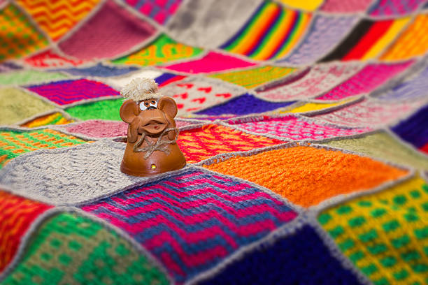 The monkey - the symbol of 2016 on a background of hand-knitted plaid