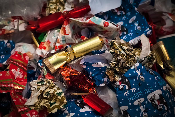 Christmas aftermath Crumpled and discarded wrapping paper and christmas crackers christmas chaos stock pictures, royalty-free photos & images