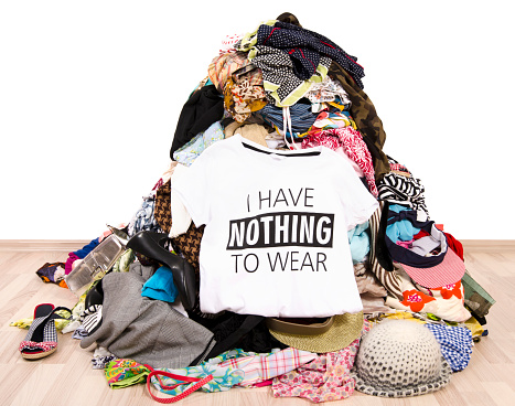 Pile of many clothes and a nothing to wear top.