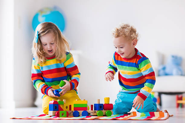istock Kids playing with wooden toy train 500464760
