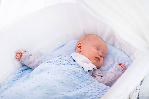 istock Baby boy in a crib under knitted blanket 500465772