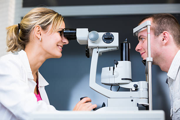 istock Optometry concept - pretty young woman having her eyes examined 500473067