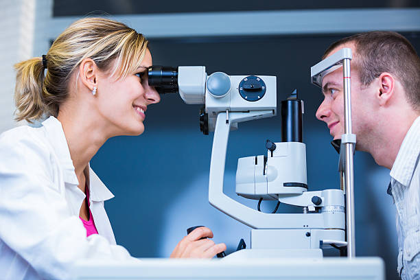 istock Young man having his eyes examined by optometrics 500473085