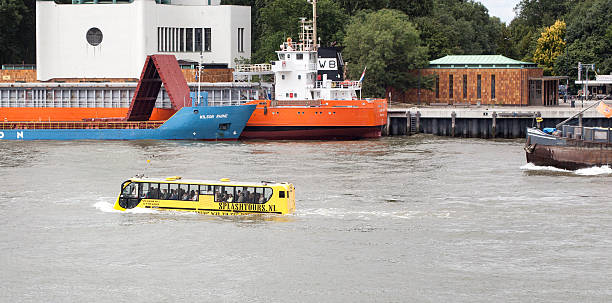 DAT Amfibus of Splashtours Rotterdam, The Netherlands - June 20, 2014: DAT Amfibus and passengers on River Maas in the Port of Rotterdam. The DAT Amfibus is an amphibious bus model of Dutch vehicle builder Dutch Amfibious Transport Vehicles. The bus has been specially developed for use in rivers and canals. amphibious vehicle stock pictures, royalty-free photos & images