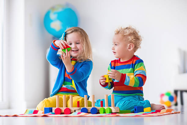 istock Kids playing with wooden toy train 500479164