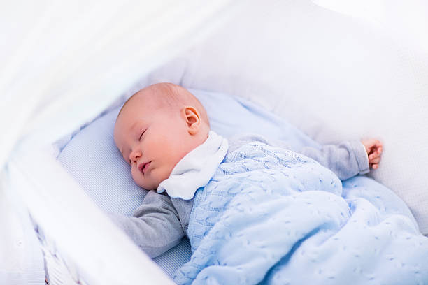 istock Baby boy in a crib under knitted blanket 500479362
