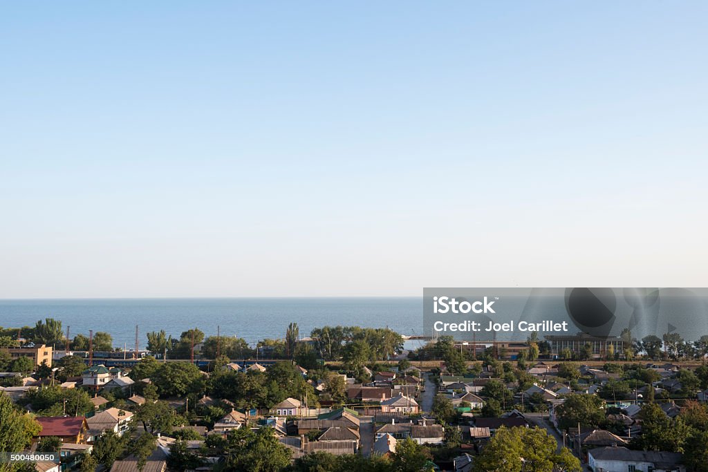 Mariupol and Sea of Azov in Ukraine View of homes, the train track, and the Azov Sea in Mariupol, Ukraine Mariupol Stock Photo