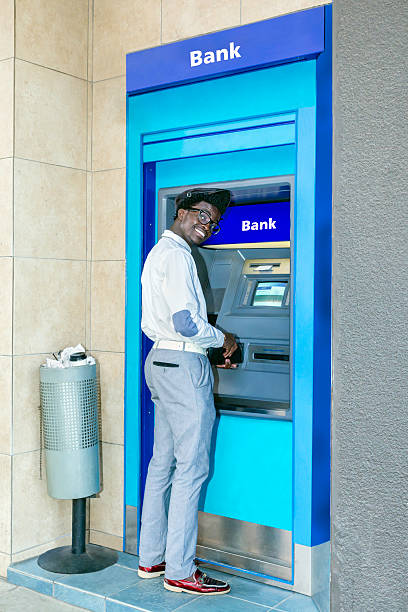 istock African man smiling at the ATM bank teller 500480077