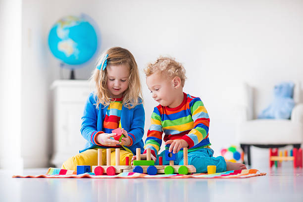 istock Kids playing with wooden toy train 500480660
